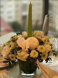 Flower table arrangement made of  santini, orchids, roses and freesia all white